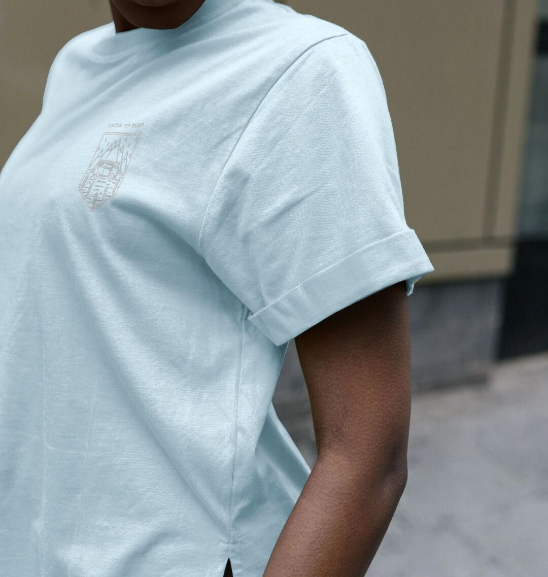 Woman wearing a sustainable organic cotton women's graphic tee with vibrant beach-inspired design