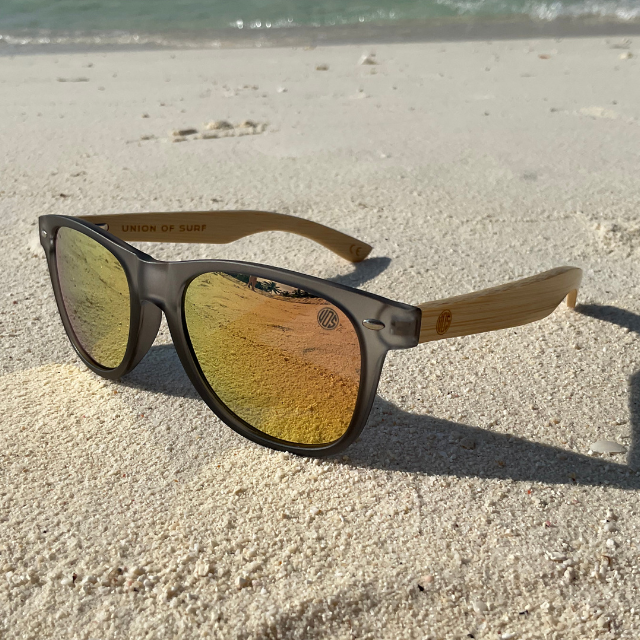 Kuta Beach-Colour Party polarised sunglasses with wooden temples on white sand.