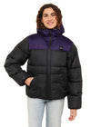 Sisstrevolution Rita Puff Jacket with black and deep purple color-block panels, quilted puffer construction, hood, and zip front.