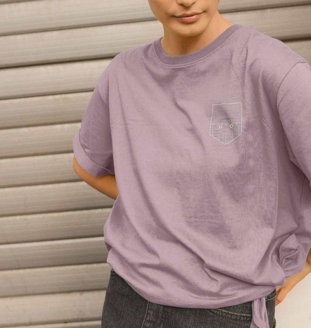 Woman wearing vibrant organic cotton graphic tee from Kooks on the Road collection, styled for casual beach vibes