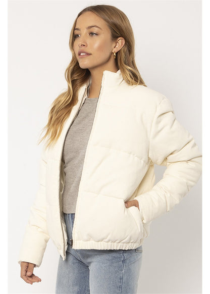 Sisstrevolution Bells Jacket in cream quilted fabric, featuring a stand collar, front zip, and elasticated hem.