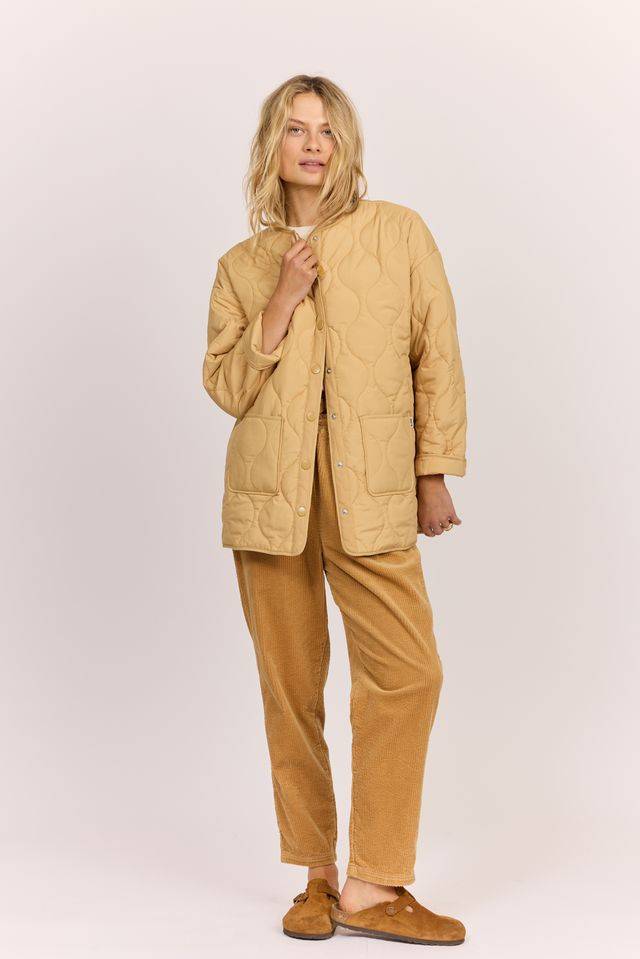 Sisstr Life Lately quilted jacket in tan with a stitched wavy pattern, snap-front closure, and rounded collarless neckline.