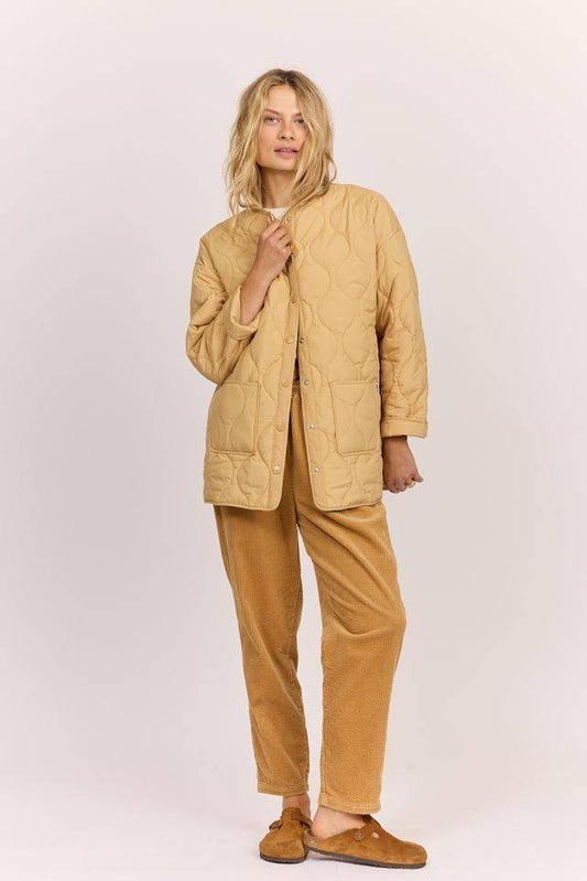 Sisstr Life Lately quilted jacket in tan with a stitched wavy pattern, snap-front closure, and rounded collarless neckline.