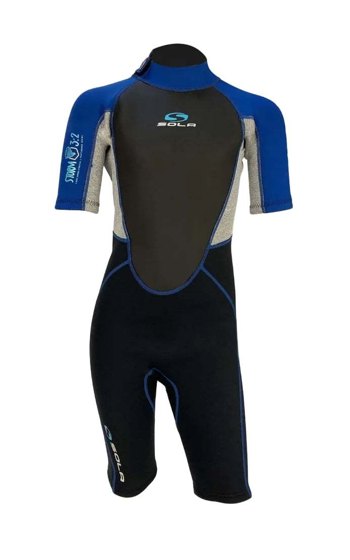 Sola Storm Kids shorty wetsuit in blue and black neoprene, with short sleeves, knee-length legs and contrast panels.