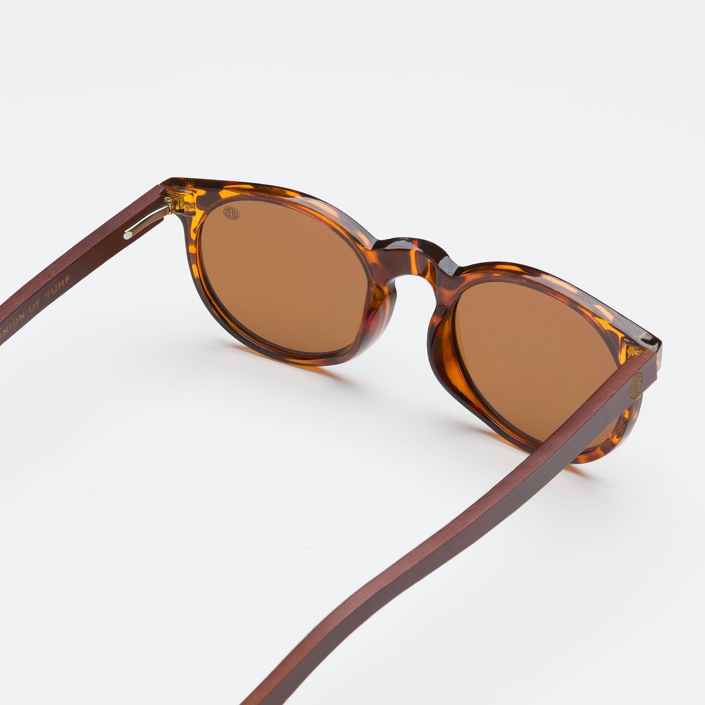 Mini Malibu sunglasses with circular pink camo frame, wooden arms, and rose gold polarized lenses