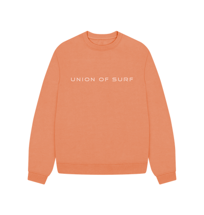 Peach-colored Union of Surf soft touch sweater with white chest text.