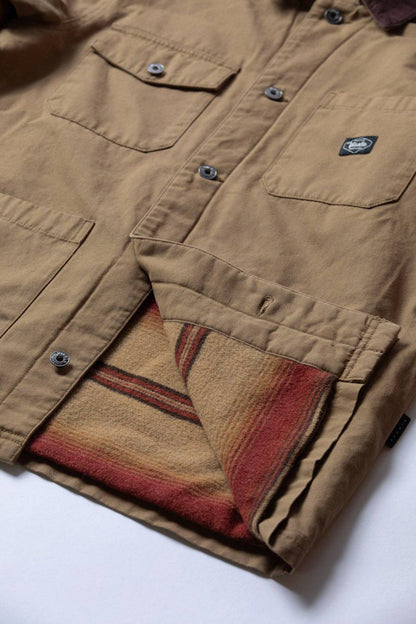 Vissla Peterson Jacket in tan cotton canvas with buttoned chest pockets, dark collar and striped red and beige lining